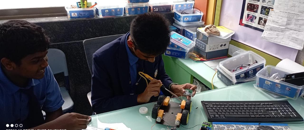 Students assembling a robotics car kit